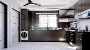 A house for sale in Accra Ghana. A wide shot of a modern kitchen with most of the cabinets facing the camera. The cabinets have a wooden brown colour theme