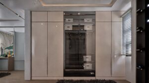 A house for sale in Accra Ghana. A light-shade beige coloured built-in wardrobe with a glass encasement in the middle.