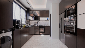 A long shot view of a beautiful modern kitchen with light grey tiled floor and wooded shaded cabinets.