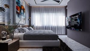A house for sale in Ghana. A luxury bedroom with a nicely laid bed with a white bedsheet. The bed view from the camera is a right side view