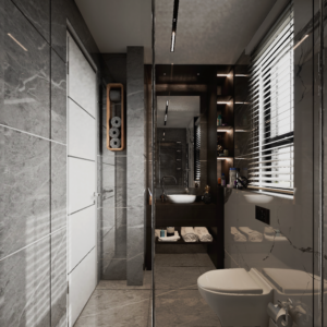 A view of a modern bathroom at Regimanuel Satellite City with shades of grey wall tiles. Also in close view is the WC which is in-built on the left wall and closer to the camera
