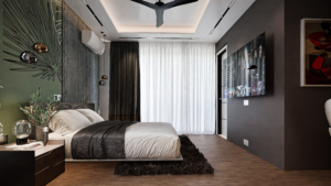 A view of a modern bedroom at Regimanuel Satellite City with light grey floor tiles. Also in close view is the flat TV which is in-built on the left wall and closer to the camera