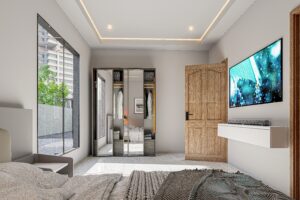 A well spaced room in a 3 bedroom house for sale in Accra Ghana - The right side of this view shows the television facing the bed and the left side is a large glass window that brings in light - Regimanuel Satellite City