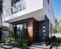 A house for sale on off-plan installment - This is a white 2 bedroom semi-detached house at Regimanuel Satellite City at East Legon Hills showing the frontage with a wooden facade and parking space.