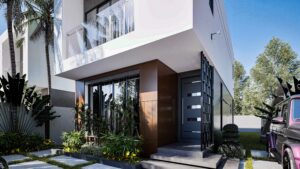 A house for sale on off-plan installment - This is a white 2 bedroom semi-detached house at Regimanuel Satellite City at East Legon Hills showing the frontage with a wooden facade and parking space.