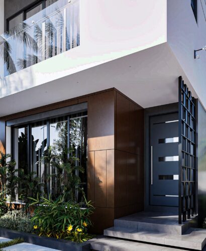 A house for sale on off-plan installment - This is a white 2 bedroom semi-detached house at Regimanuel Satellite City at East Legon Hills showing the frontage with a wooden facade and parking space.